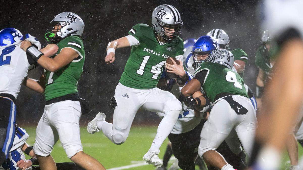 Emerald Ridge quarterback Jake Schakel leaps into the end zone for a two-point conversion during Friday night’s 4A district football game against the Bothell Cougars at Sparks Stadium in Puyallup, Washington, on Nov. 3, 2023. Emerald Ridge won the game, 50-36.