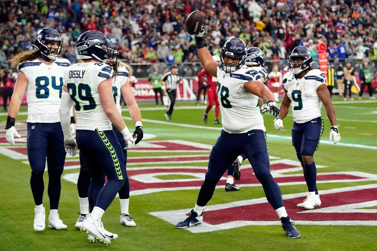 Seattle Seahawks offensive tackle Stone Forsythe (78) celebrates after teammate Will Dissly (89) scored a touchdown against the Arizona Cardinals in the first half of an NFL football game Sunday, Jan. 7, 2024, in Glendale, Ariz. (AP Photo/Ross D. Franklin)