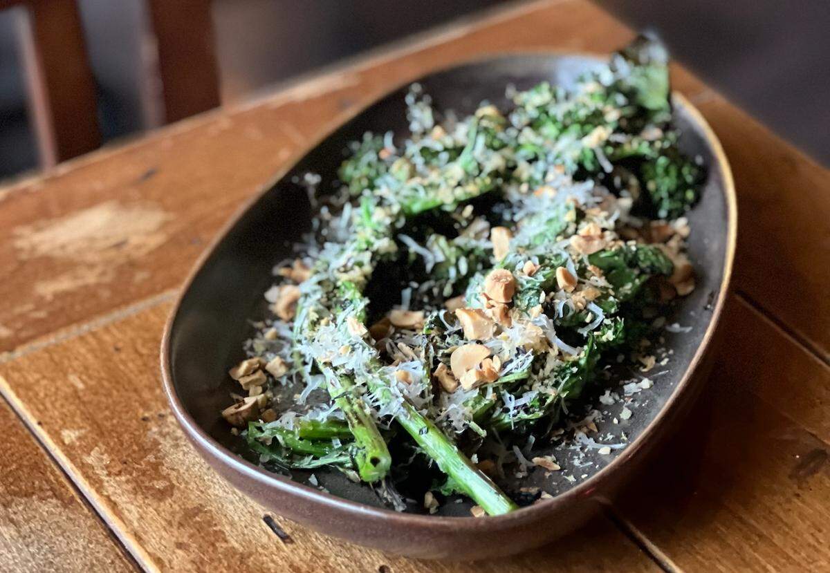 Shareables and sides include greens like grilled rapini with pangrattato, parm and hazelnuts.
