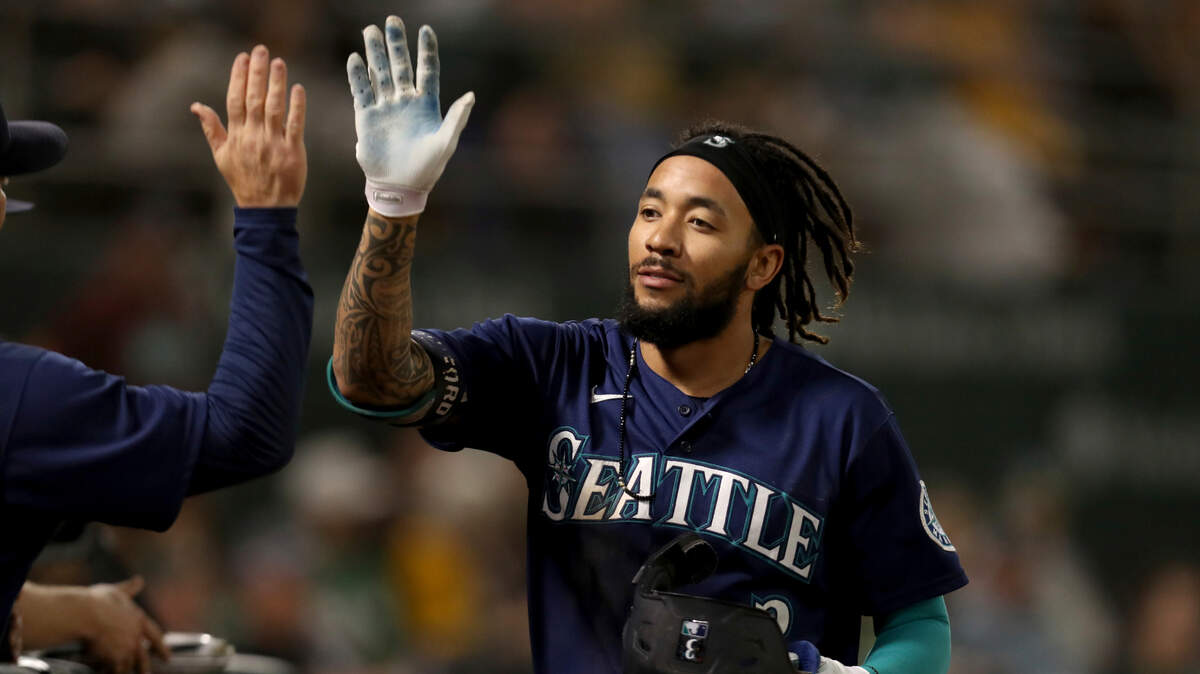 Seattle Mariners’ J.P. Crawford is congratulated by teammates after hitting a solo home run against the Oakland Athletics during the eighth inning of a baseball game in Oakland, Calif., Tuesday, Sept. 21, 2021. (AP Photo/Jed Jacobsohn)