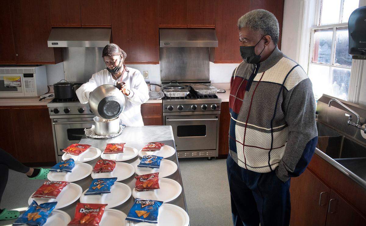 Pastor Gregory Christopher visits with kitchen staff Patricia Adams at the Shiloh Baptist Church’s new Retreat Center and homeless shelter in Tacoma, Washington, on Wednesday, Nov. 17, 2021.