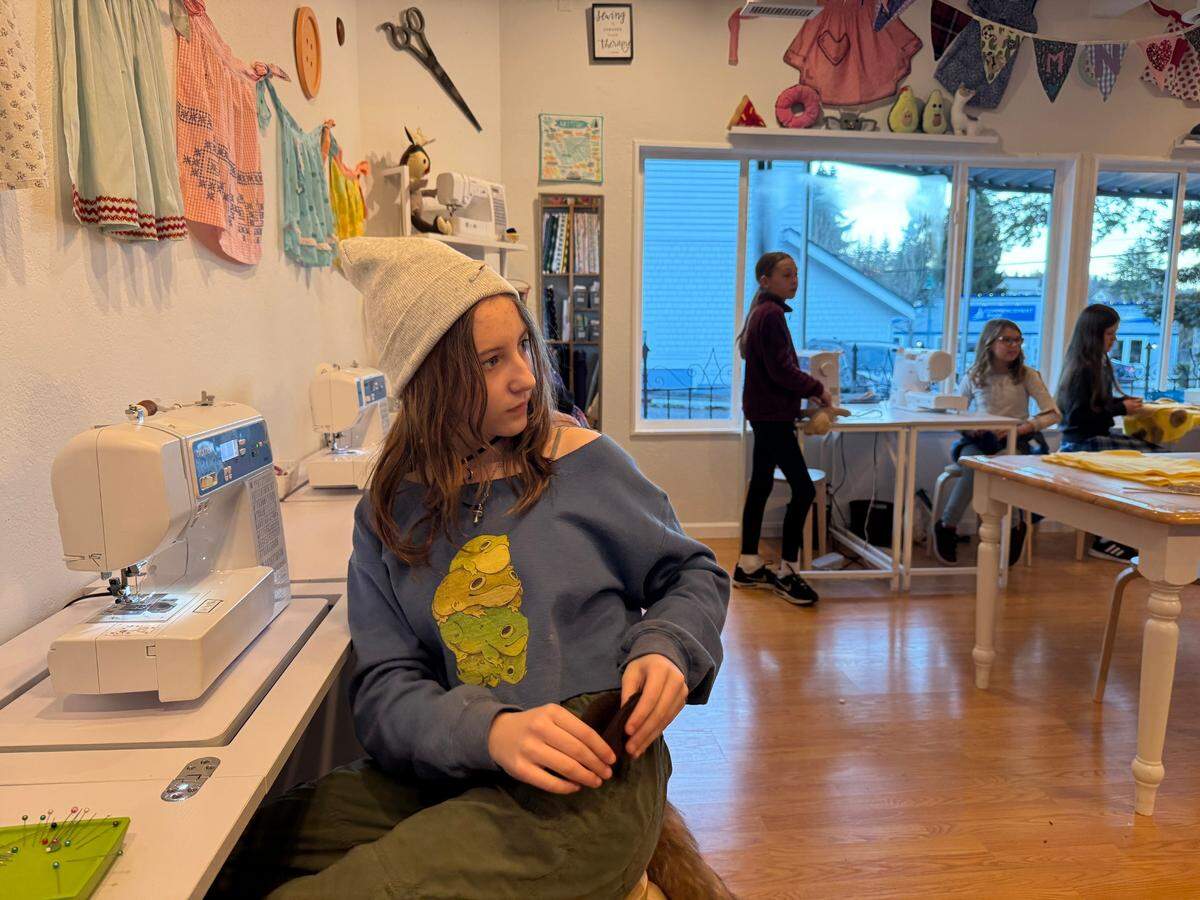 Violet Hake, 12, turns to look at her teacher, Jenny Czyzewski, during an afternoon sewing class in Gig Harbor, Wash., Monday, Feb. 10, 2025. Today, she’s working on sewing a teddy bear with two heads and wings, she said.