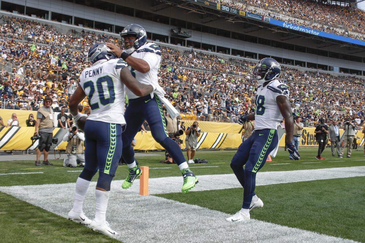 Seattle Seahawks running back Rashaad Penny (20) celebrates with teammates after he hit the end zone after a long touchdown run against the Pittsburgh Steelers in the second half of an NFL football game, Sunday, Sept. 15, 2019, in Pittsburgh. (AP Photo/Don Wright)