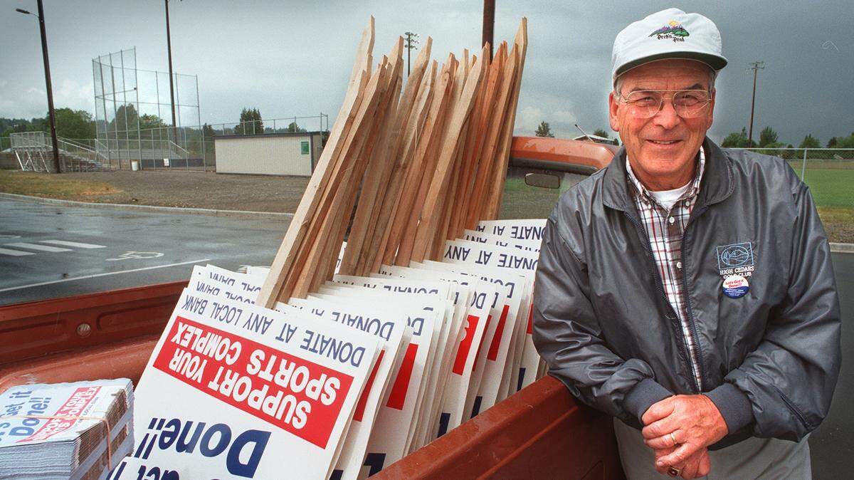 BIll Heath and his pickup (filled with the pickets and color flyers he circulates promoting a news sports complex, at the site of the Daffodil Valley Sports Complex in Sumner in 1996.