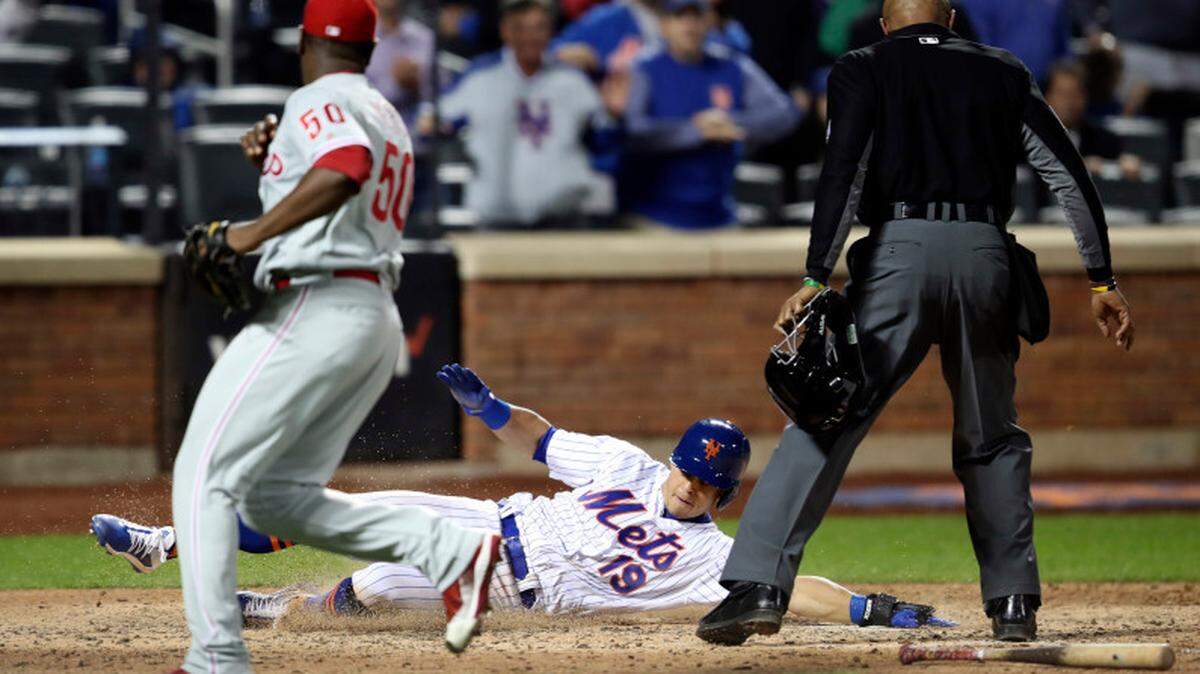 New York Mets’ Sam Haggerty (19) scores past Philadelphia Phillies relief pitcher Hector Neris (50) on an RBI-single by Pete Alonso during the eighth inning of a baseball game Friday, Sept. 6, 2019, in New York.