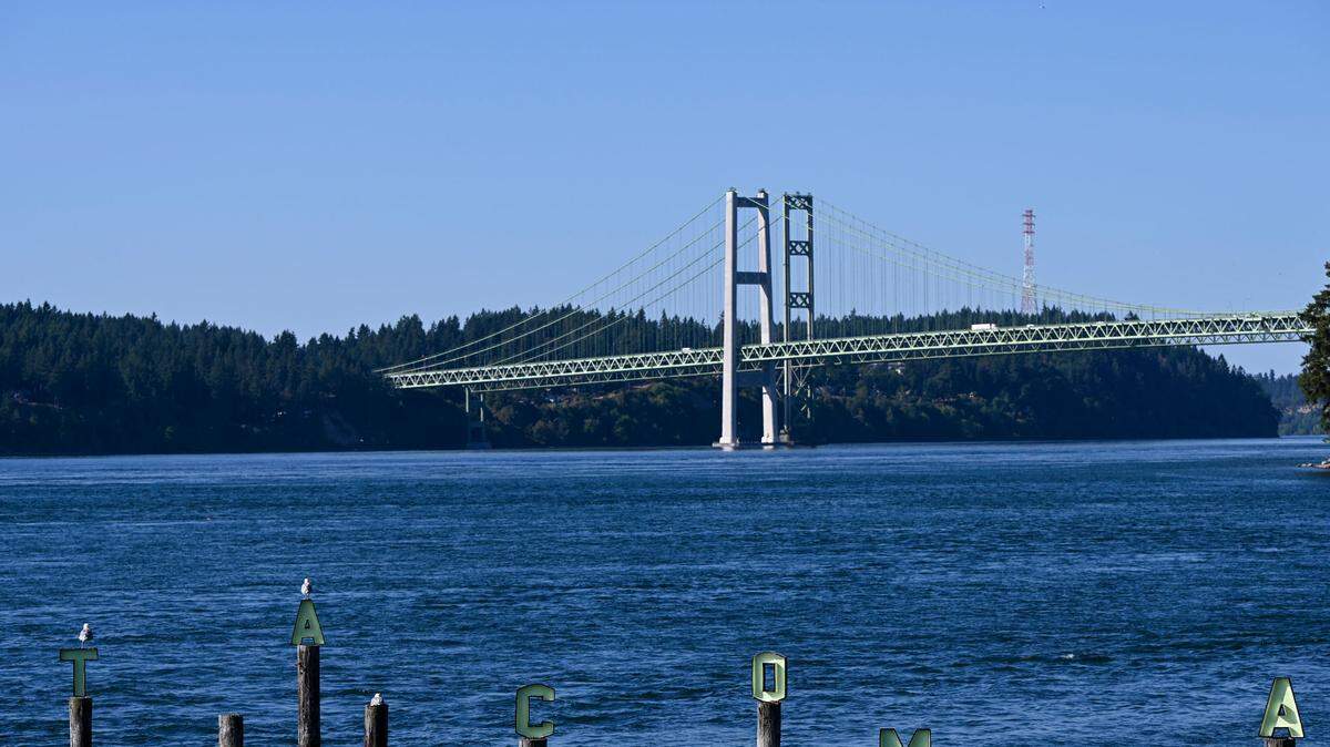A “TACOMA” sign is seen in front of the Tacoma Narrows bridge at Titlow Park, Tuesday, Aug. 1, 2023, in Tacoma.