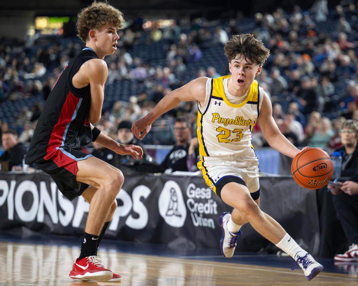 Puyallup guard Drew Jones (23) drives to the basket as West Valley guard Austin Birley (20) defends during the second quarter of a Class 4A state basketball tournament semifinal game at the Tacoma Dome on Friday, March 7, 2025, in Tacoma, Wash.
