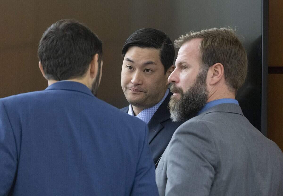 Tacoma Police Officers (l-r) Christopher Burbank, Timothy Rankine and Matthew Collins chat before the beginning of their trial regarding the killing of Manny Ellis in Pierce County Superior Court, Thursday, Nov. 30, 2023, in Tacoma, Wash. Tacoma Police Officers Christopher Burbank, Matthew Collins and Timothy Rankine stand trial for charges related to the March 2020 killing of Manny Ellis. (Ellen M. Banner / Pool / The Seattle Times)