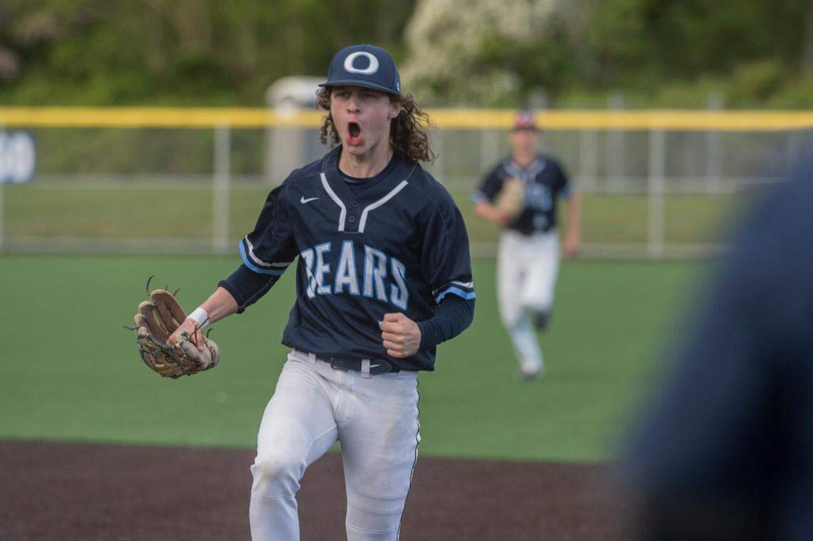 Olympia High School infielder Zach Fuller celebrates during the Class 4A West Central/Southwest bidistrict championship game on Saturday, May 14, 2022 at Kent-Meridian High School in Kent, Wash. Olympia beat Puyallup, 8-4, for the title.
