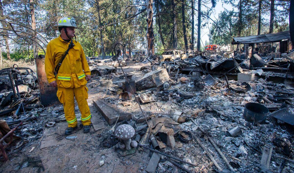 Graham Fire & Rescue Battalion Chief Mike Fortier surveys the damage caused by a September 2020 wildfire, calling it the most devestating fire he’s ever seen in his career.