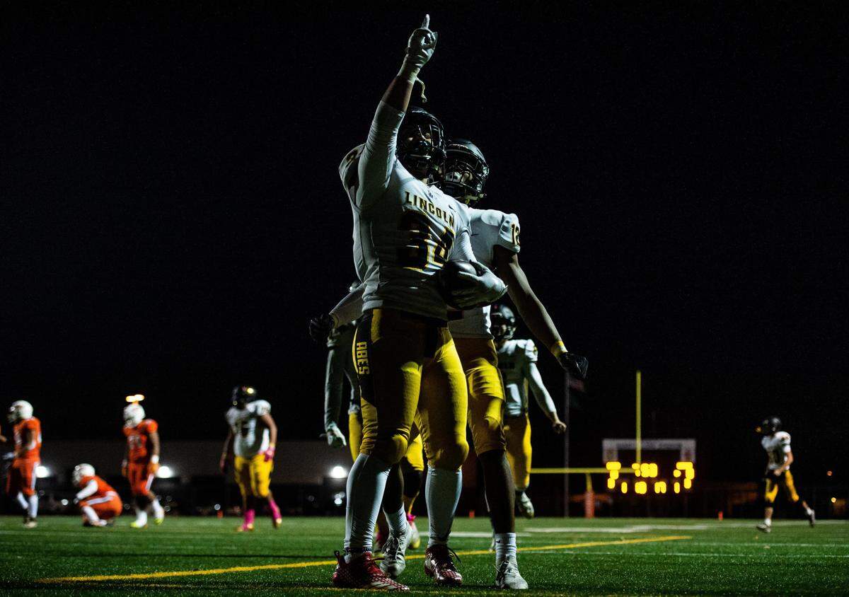 Lincoln’s Abner Sio-Fetaui (34) celebrates his touchdown run during the first quarter. Lincoln played Lakes in a football game at Harry Lang Stadium in Lakewood, Wash., on Friday, Oct. 25, 2019.