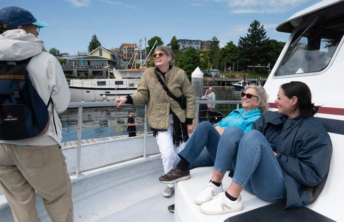 Gretchen Meisinger (from left) of Spring Hill, Kansas, Alexis Vilay of Albuquerque, New Mexico, Janis McKinstry of Brinnon, Washington, and Kacey Bake of Des Moines, Iowa chat in the sunshine as they arrive at Friday Harbor, Washington, on San Juan Island aboard the Puget Sound Express’ Red Head whale watching passenger ferry on Monday, June 26, 2023.