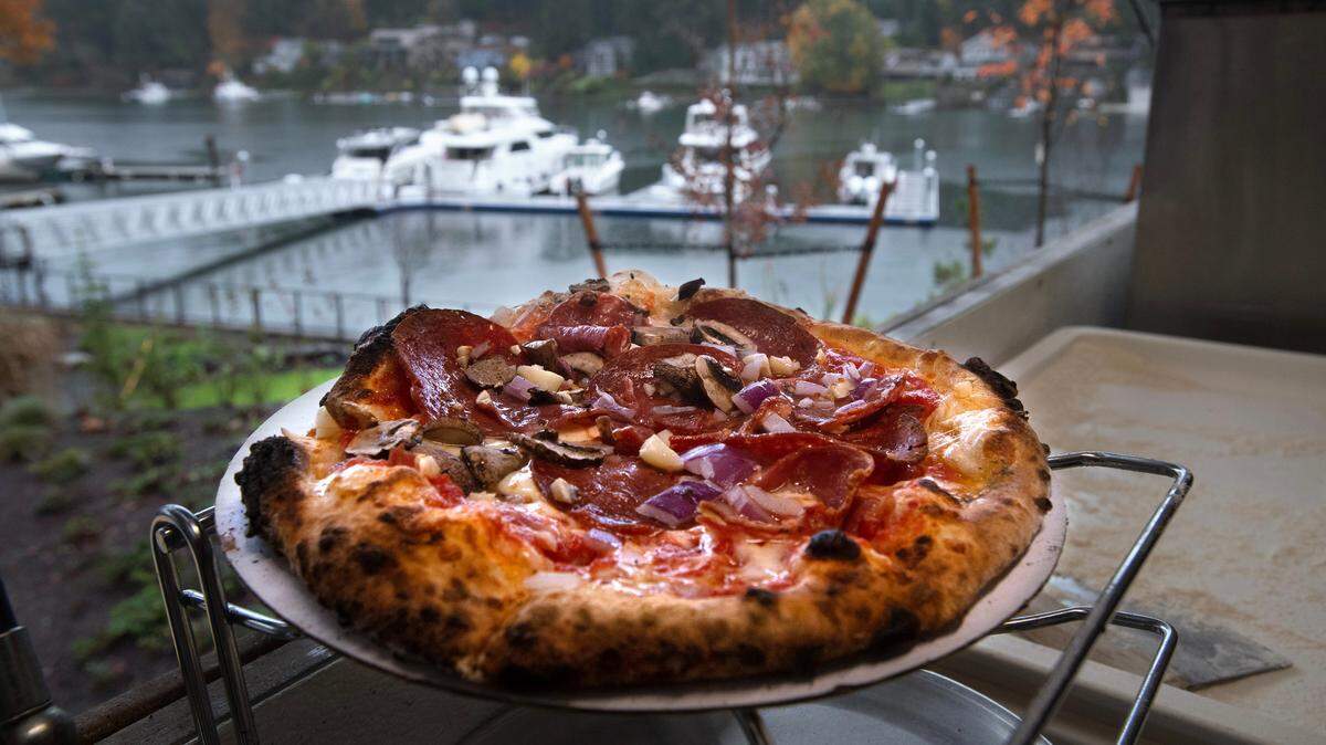 A pizza fresh out of the oven at the Millville at 7 Seas wood-fired pizza truck in the parking lot of 7 Seas Brewing on the waterfront in Gig Harbor, Washington, on Monday, Nov. 6, 2023.