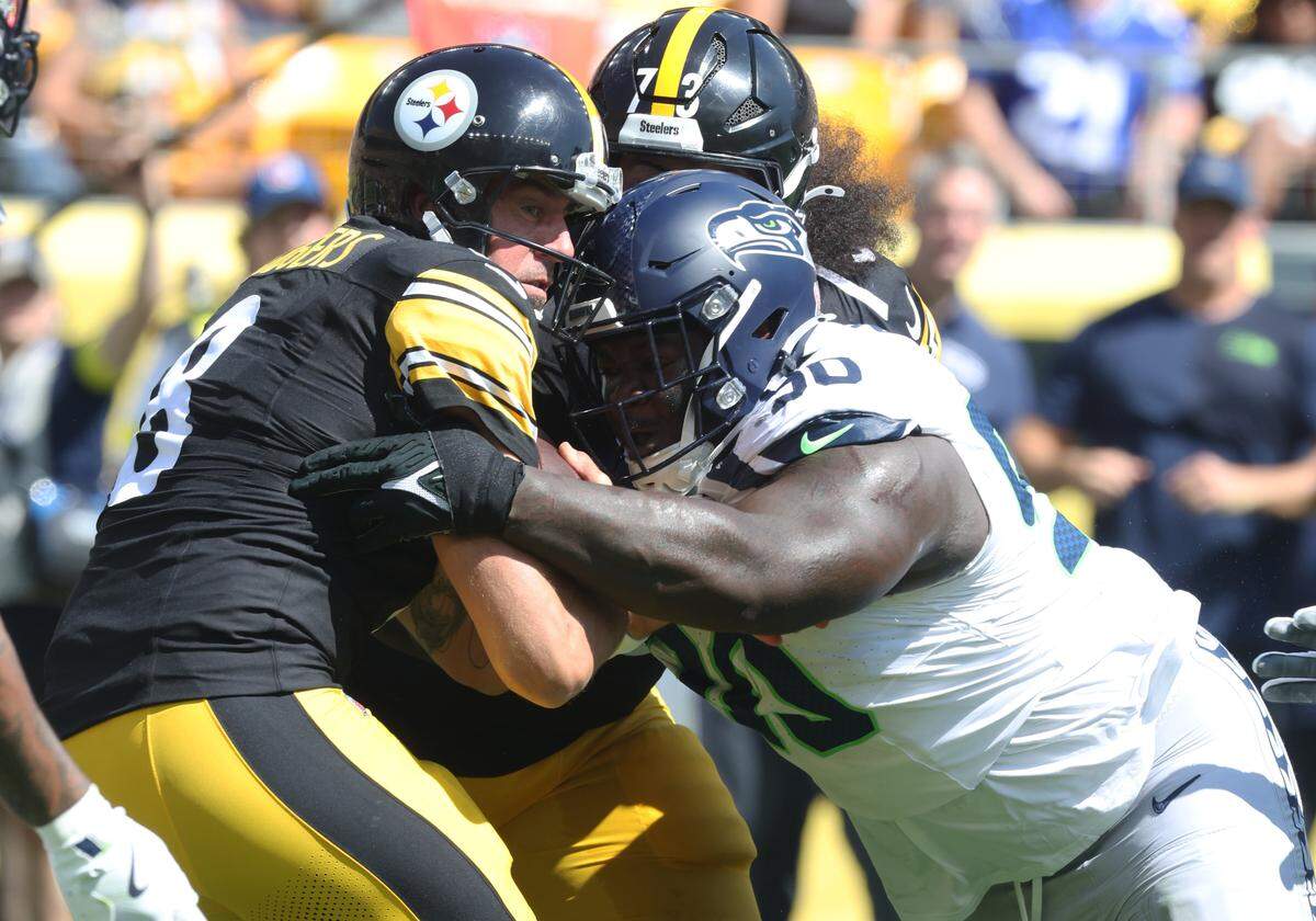 Sep 14, 2025; Pittsburgh, Pennsylvania, USA; Seattle Seahawks defensive tackle Jarran Reed (90) sacks Pittsburgh Steelers quarterback Aaron Rodgers (8) during the second quarter at Acrisure Stadium. Mandatory Credit: Charles LeClaire-Imagn Images