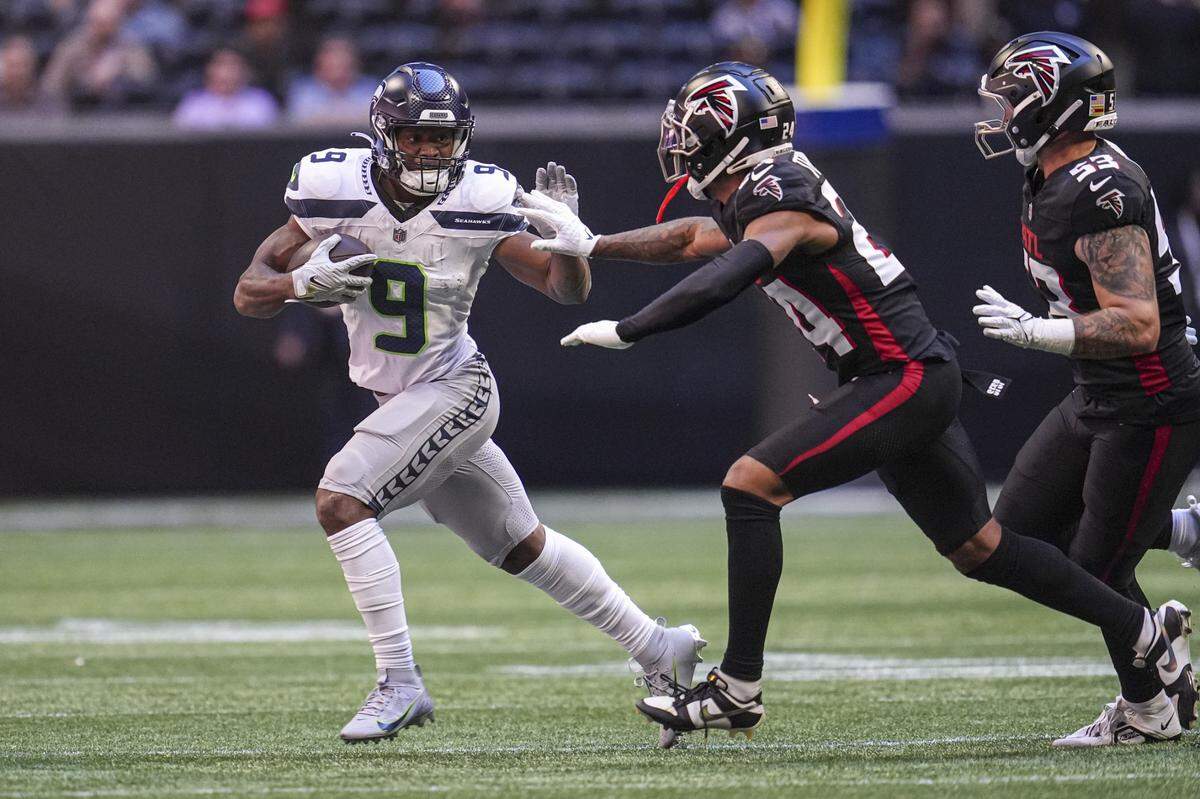 Oct 20, 2024; Atlanta, Georgia, USA; Seattle Seahawks running back Kenneth Walker III (9) runs against Atlanta Falcons cornerback A.J. Terrell (24) during the first quarter at Mercedes-Benz Stadium. Mandatory Credit: Dale Zanine-Imagn Images