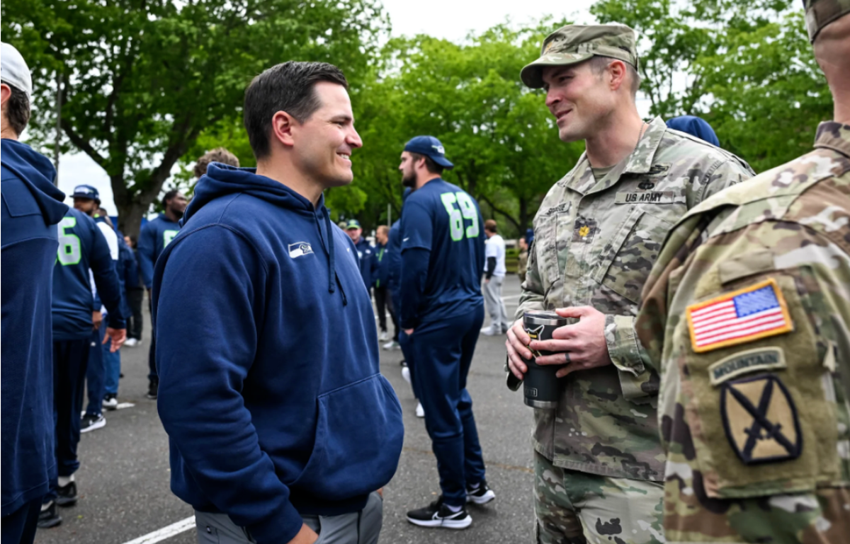 Seahawks coach Mike macdonald with a major from the 1-2 Stryker Brigade Combat Team at Joint Base Lewis-McChord during the team’s visit to the U.S. Army unit in Pierce County June 4, 2024.
