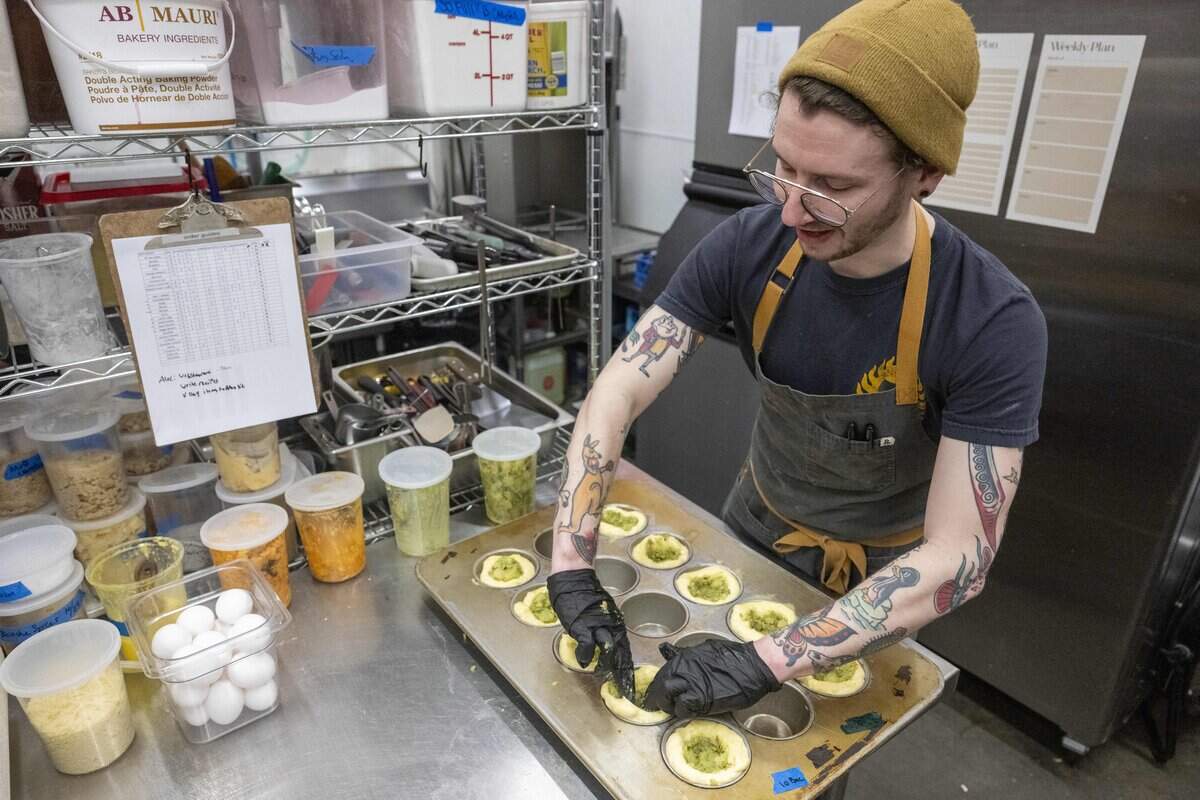 Three Hearts pastry chef Alec Young stuffs brioche buns with savory potato filling on Friday, Jan. 23, 2026, in Tacoma, Wash.