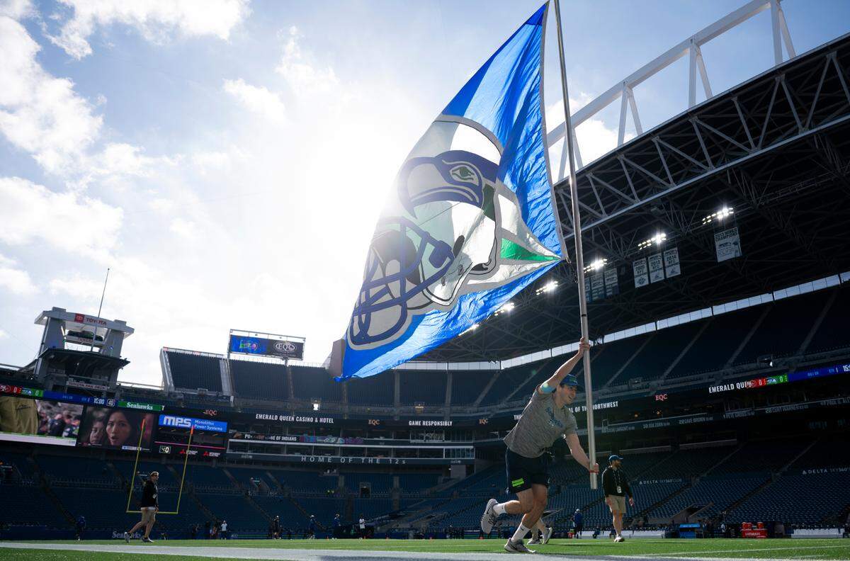 Flag-wavers practice before the game between the Seattle Seahawks and the San Francisco 49ers at Lumen Field, on Thursday, Oct. 10, 2024, in Seattle, Wash.