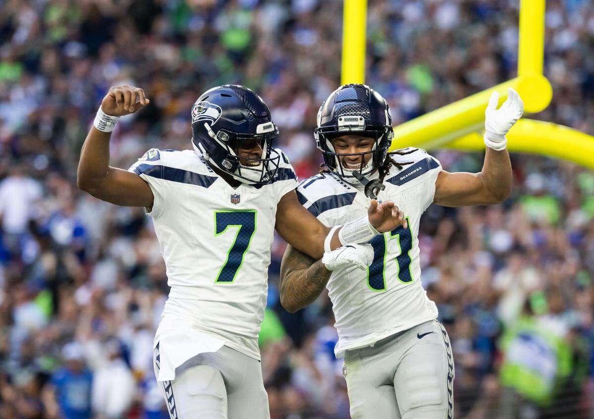 Seattle Seahawks quarterback Geno Smith (7) celebrates a touchdown with wide receiver Jaxon Smith-Njigba (11) against the Arizona Cardinals in the first half at State Farm Stadium. Mandatory Credit: Mark J. Rebilas-Imagn Images