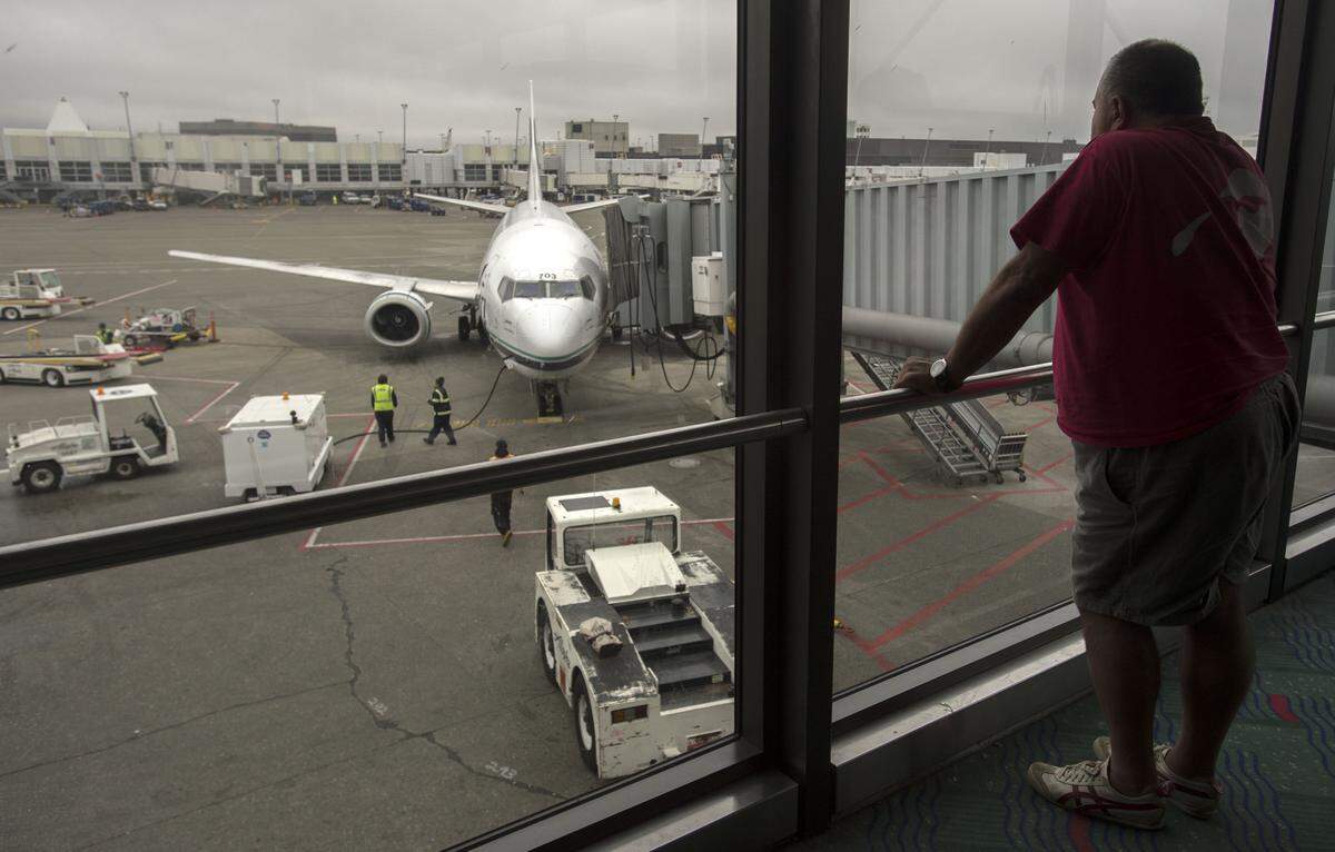 An Alaska Airlines passenger waits to board his flight at the north terminal at Sea-Tac Airport in 2015. 