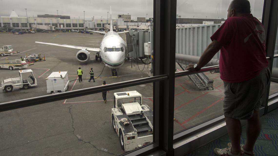 An Alaska Airlines passenger waits to board his flight at the north satellite terminal at Seattle-Tacoma Airport. As part of Sea-Tac’s ongoing growth, it recently opened a 201,000 square foot expansion of the north terminal.