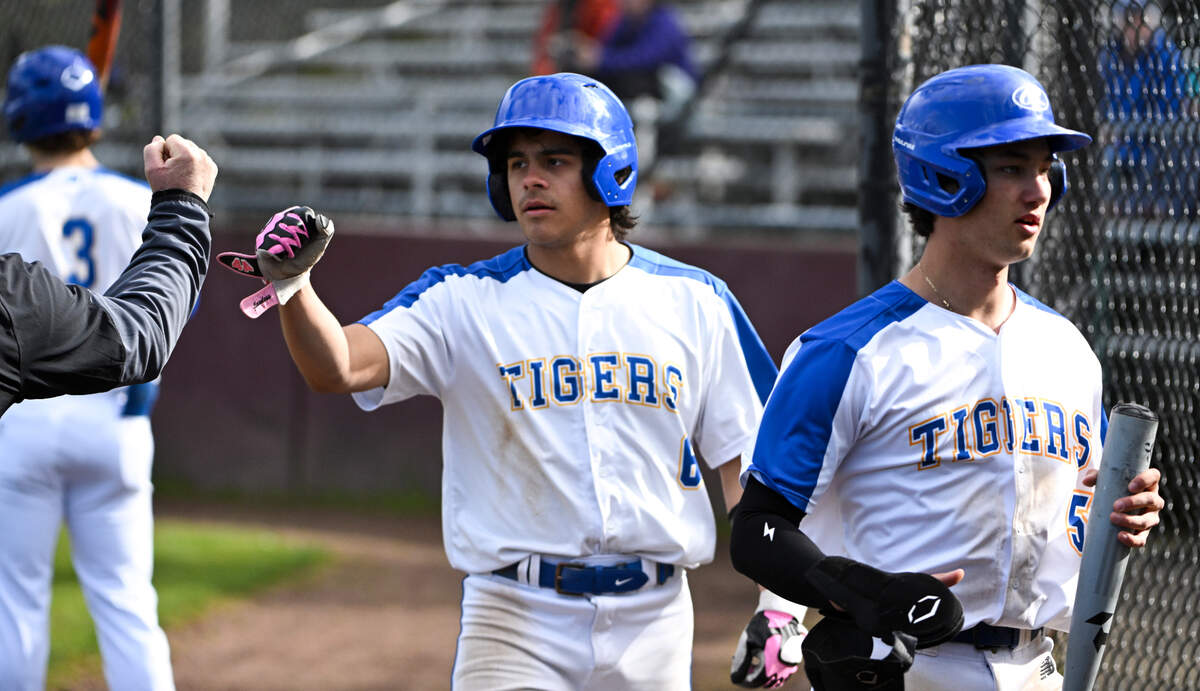 Stadium’s Payton Lopez (6) and Jesse Winkler (5) walk into the dugout after scoring two runs against Mount Tahoma during the game at Heidelberg Field, on Tuesday, April 9, 2024, in Tacoma, Wash.