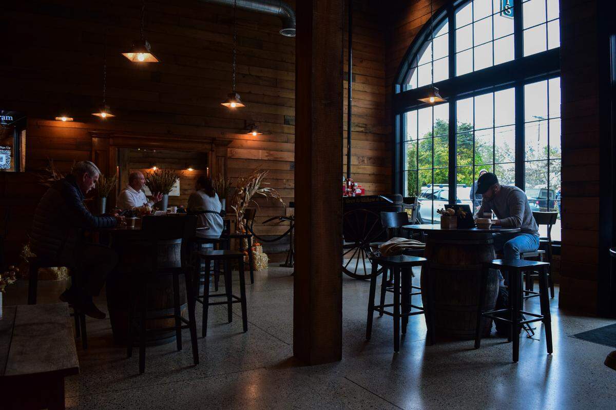 Customers linger in the airy cafe space at Wren’s Nest Baking Co. on Wednesday, Oct. 23, 2024. There are also cozy seating options around a fireplace and a rooftop patio in the warmer months.