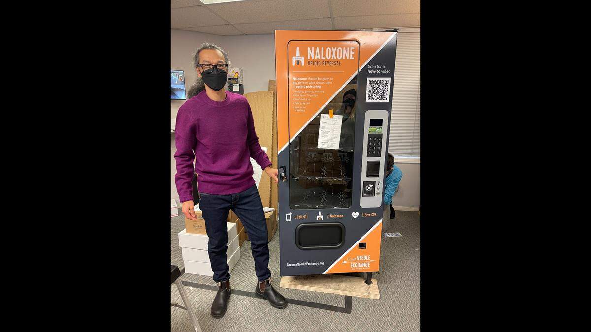 Tacoma Needle Exchange/Dave Purchase Project Executive Director Paul LaKosky stands next to one of three new naloxone vending machines. The machines will be delivered to Pierce County locations next week.