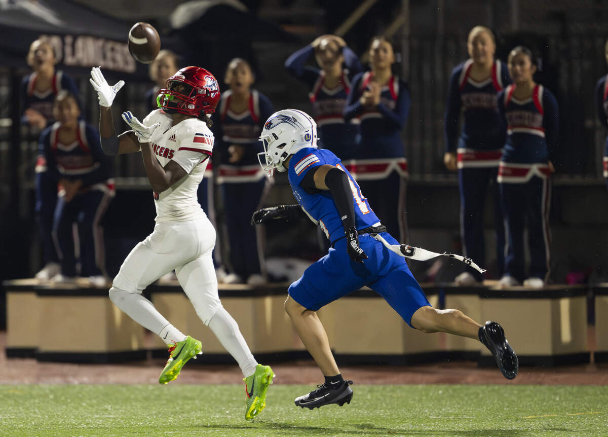 Kennedy Catholic running back Jordan Noel (3) makes a big reception as Graham Kapowsin cornerback Raymond Lagat (14) chases him during the first half of the opening round 4A state tournament game at Art Crate Field, on Saturday, Nov. 15, 2025, in Spanaway.