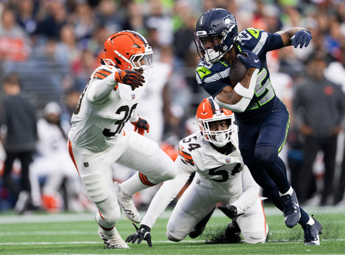 Seattle Seahawks running back Kenny McIntosh (25) breaks out for run against Cleveland Browns cornerback Tony Brown II (38) during the first quarter of the preseason game at Lumen Field, on Saturday, Aug. 24, 2024 in Seattle, Wash.