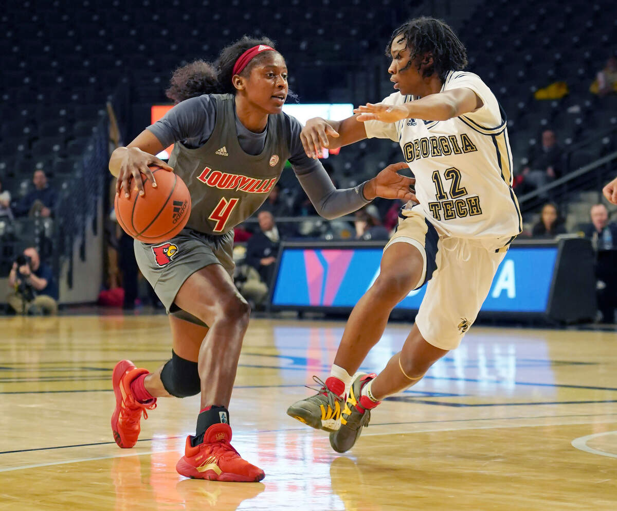 Louisville guard Elizabeth Balogun, left, drives around Georgia Tech guard Kondalia Montgomery during the second half of an NCAA college basketball game Thursday, Feb. 20, 2020, in Atlanta, Ga. (AP Photo/Tami Chappell)