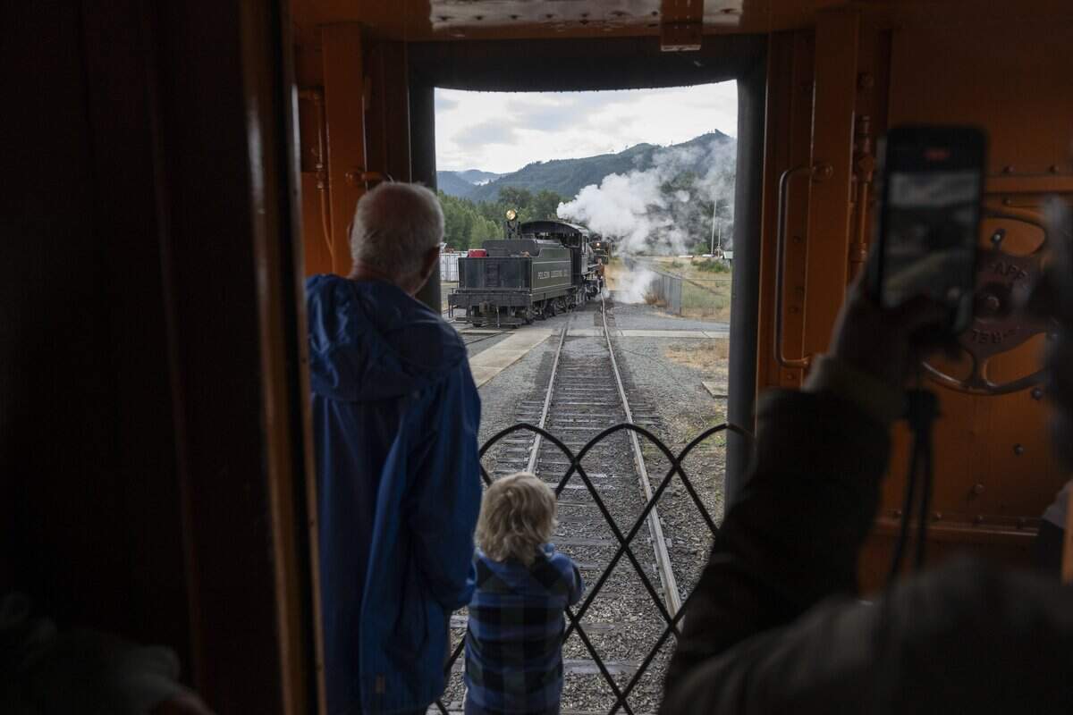 Passengers watch as the engine of the Mt. Rainier Scenic Railroad is moved from front to back to begin its return journey to Elbe on Thursday, July 16, 2026, in Mineral, Wash.