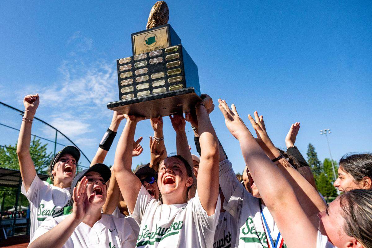 Peninsula players hoist the Class 3A championship trophy after beating Snohomish, 4-1, in the state championship game on Saturday, May 27, 2023, at Regional Athletic Complex in Lacey, Wash.