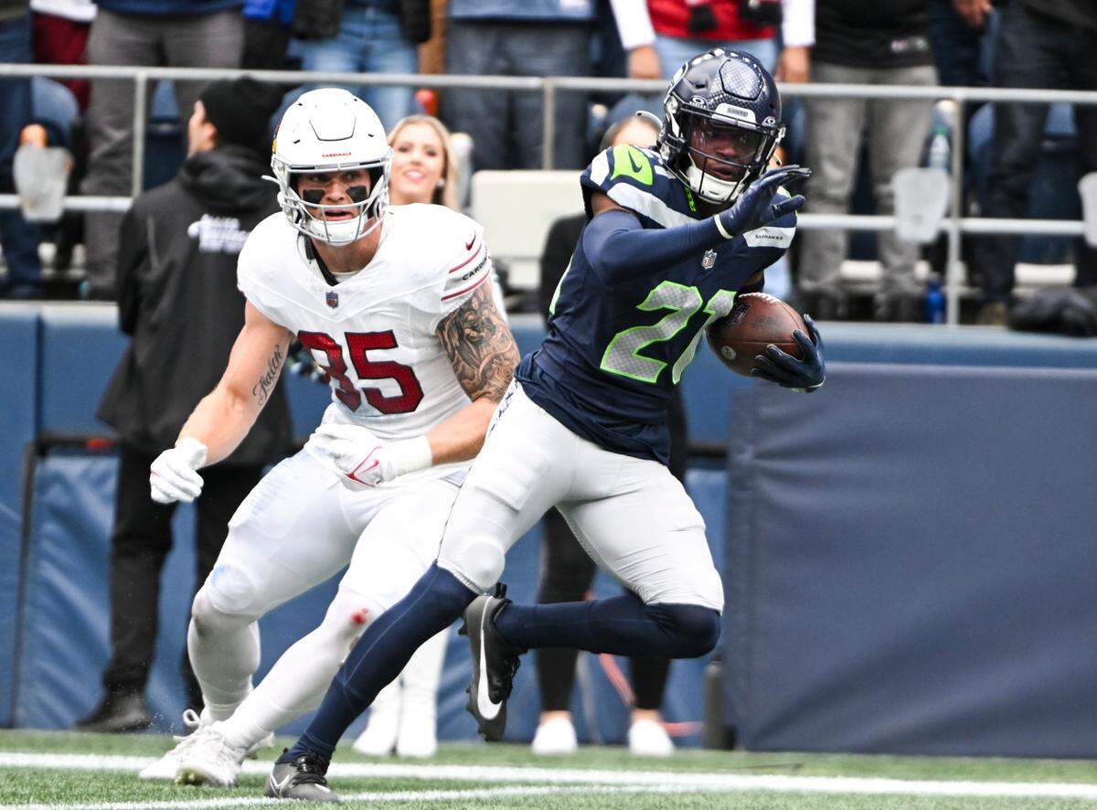 Seattle Seahawks cornerback Devon Witherspoon (21) intercepts the ball intended for Arizona Cardinals tight end Trey McBride (85) during the second quarter of the game at Lumen Field, Sunday, Oct. 22, 2023, in Seattle, Wash. The play is called back after several fouls on both teams.