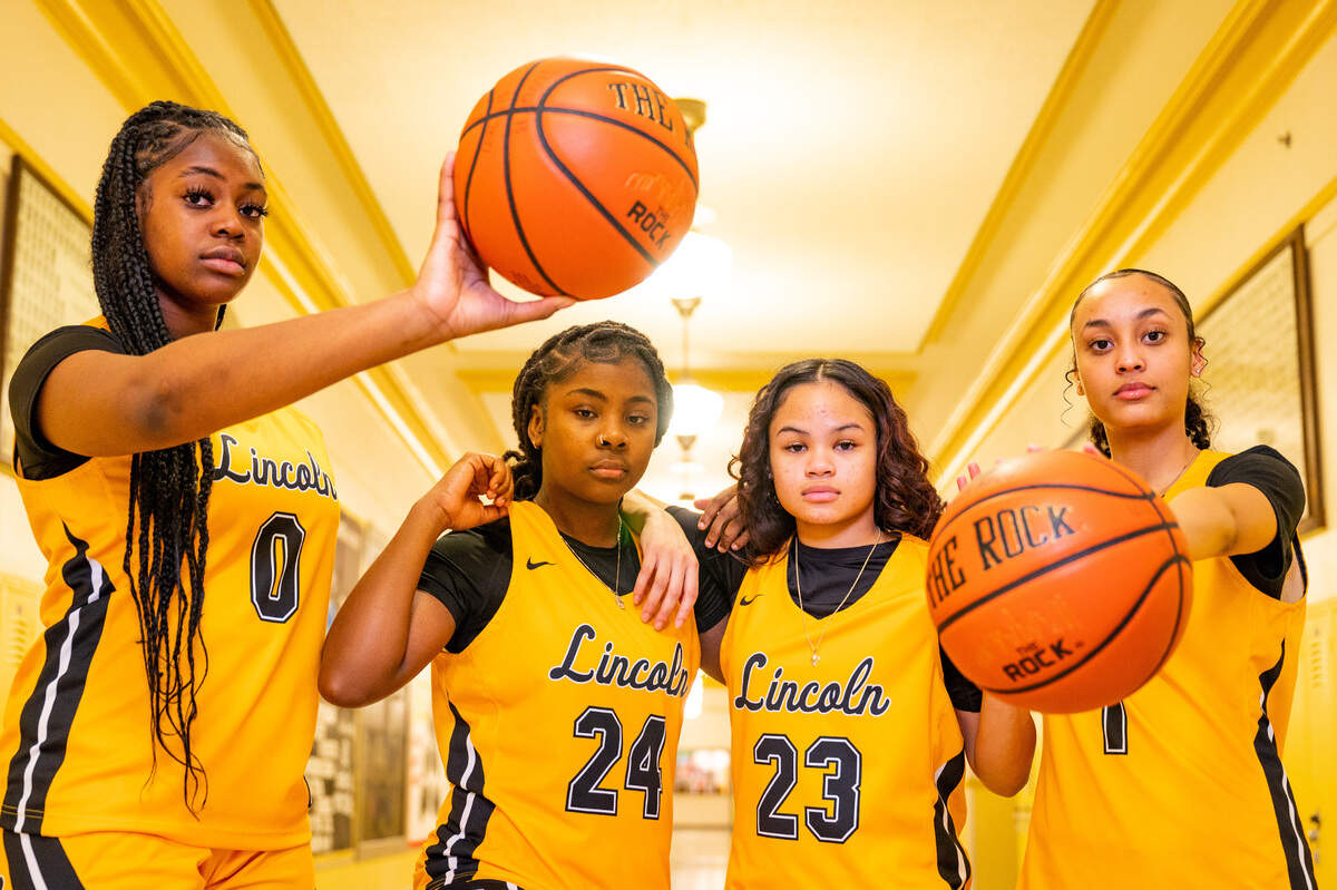 Lincoln sophomore De’Andrea Woods-Singleton (left), junior Malani Warren (center-left), sophomore Jaleigha Robinson (center-right) and Ciona Wells pose for a portrait in the hallway at Lincoln High School on Thursday, Jan. 20, 2022, in Tacoma, Wash.