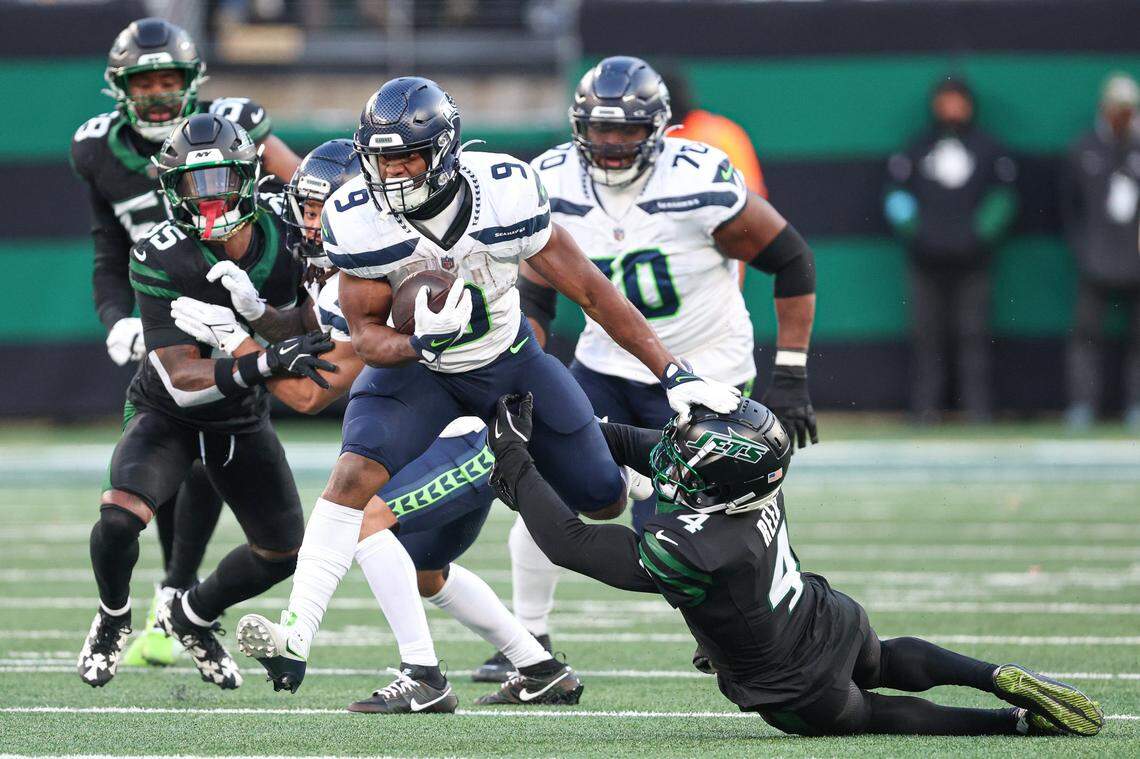 Seattle Seahawks running back Kenneth Walker III (9) is tackled by New York Jets cornerback D.J. Reed (4) during the second half at MetLife Stadium. Mandatory Credit: Vincent Carchietta-Imagn Images