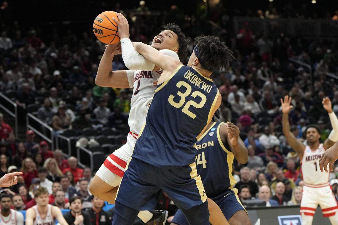 Mar 21, 2025; Seattle, WA, USA; Akron Zips forward James Okonkwo (32) fouls Arizona Wildcats forward Trey Townsend (4) during the second half in the first round of the NCAA Tournament at Climate Pledge Arena. Mandatory Credit: Stephen Brashear-Imagn Images