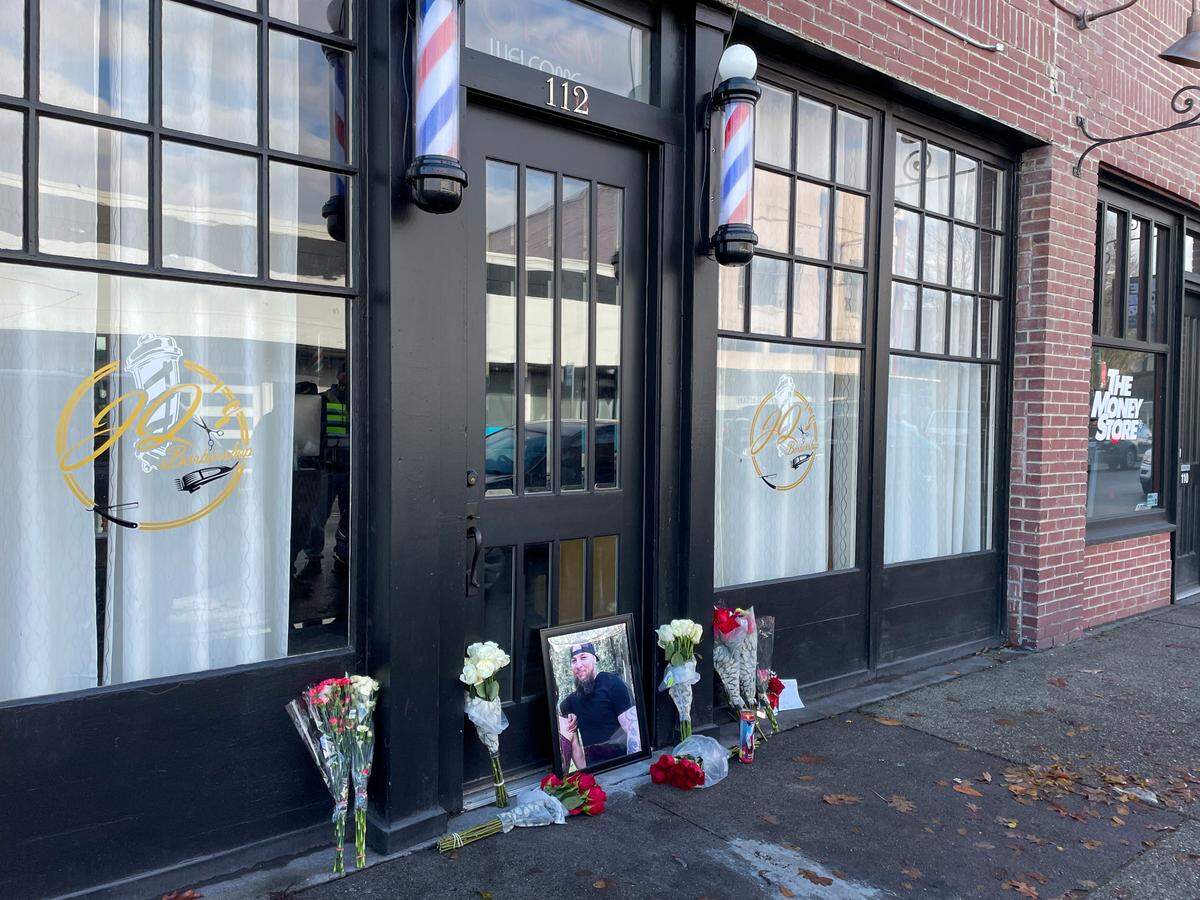 People set up a memorial for JQ’s Barbershop in Puyallup the morning after the incident.