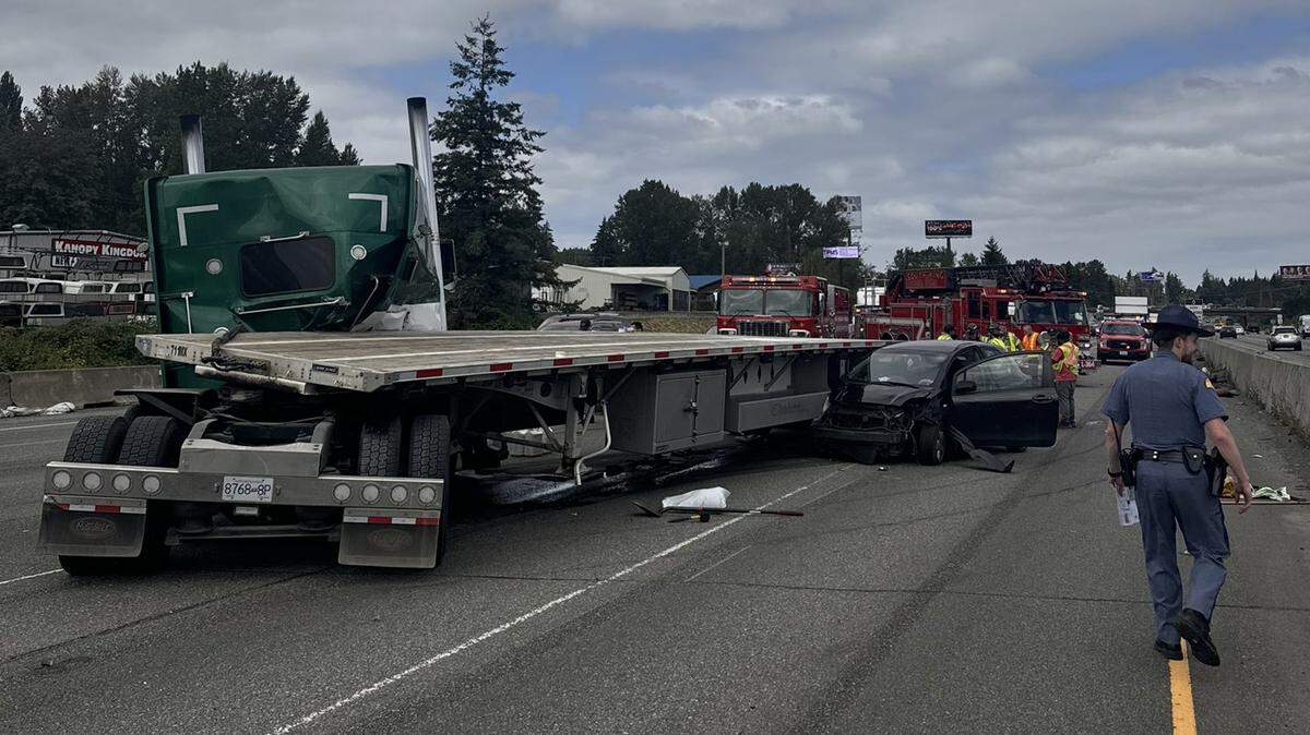 A crash involving a semi-truck and two vehicles in Pierce County has caused about a three mile backup on Tuesday, according to state troopers.