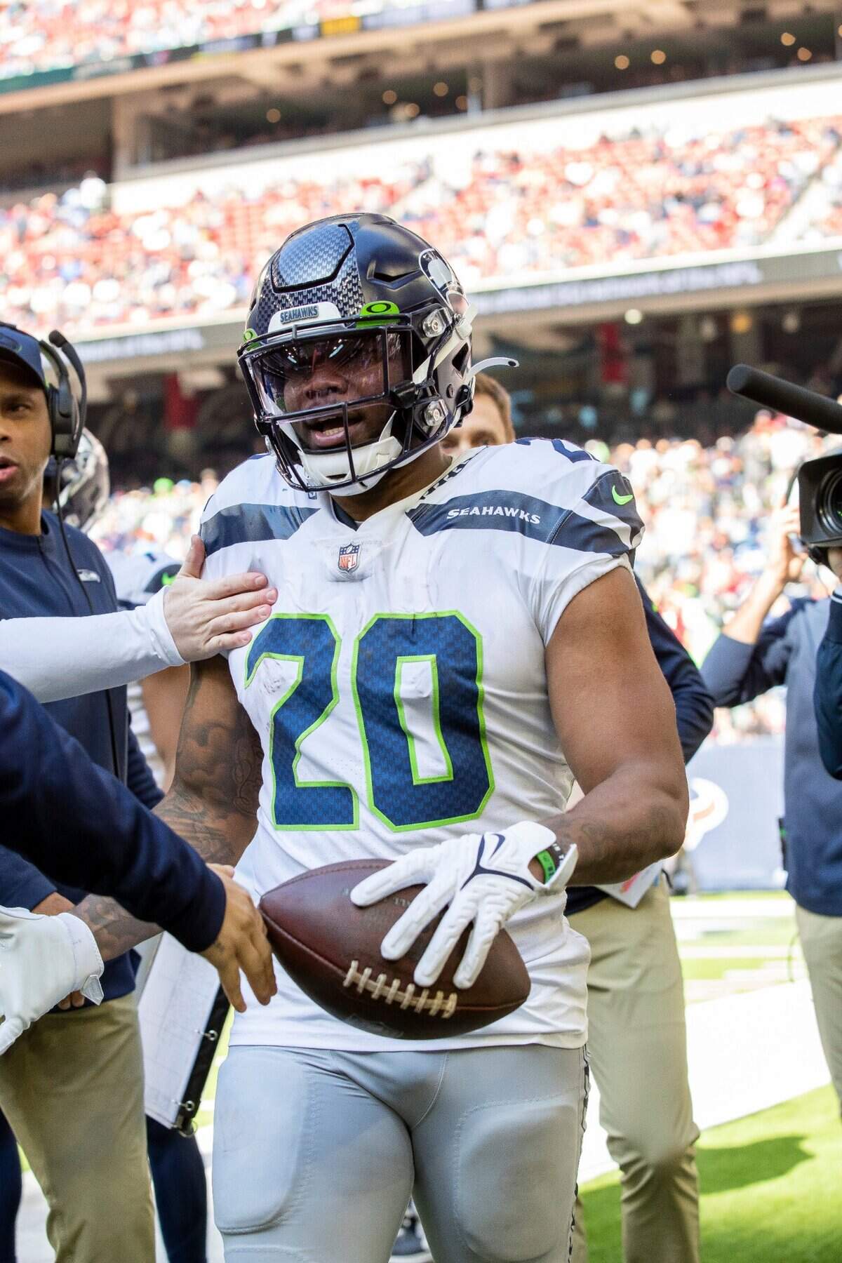Running back (20) Rashaad Penny of the Seattle Seahawks is congratulated after scoring a touchdown against the Houston texans in an NFL football game, Sunday, Dec. 12, 2021, in Houston, TX. (AP Photo/Jeff Lewis)
