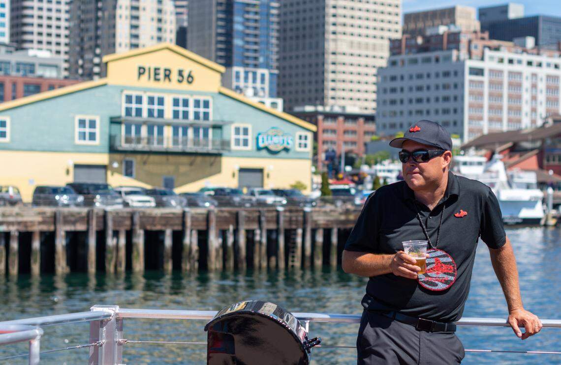 Salish Sea Tours owner Kyle Griffith, an enrolled member of the Chinook Indian Nation, rides on the tour’s catamaran Orca One during one of its first voyages Thursday, June 24, from Miner’s Landing on the Seattle waterfront. The Elliott Bay tour’s narration shares the history of the city and its Indigenous people. Griffith said the tour is a tangible representation of tribes coming together.