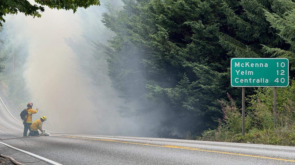 South Pierce Fire & Rescue crews battle a brush fire along State Route 702 east of Yelm on Wednesday, July 30, 2025