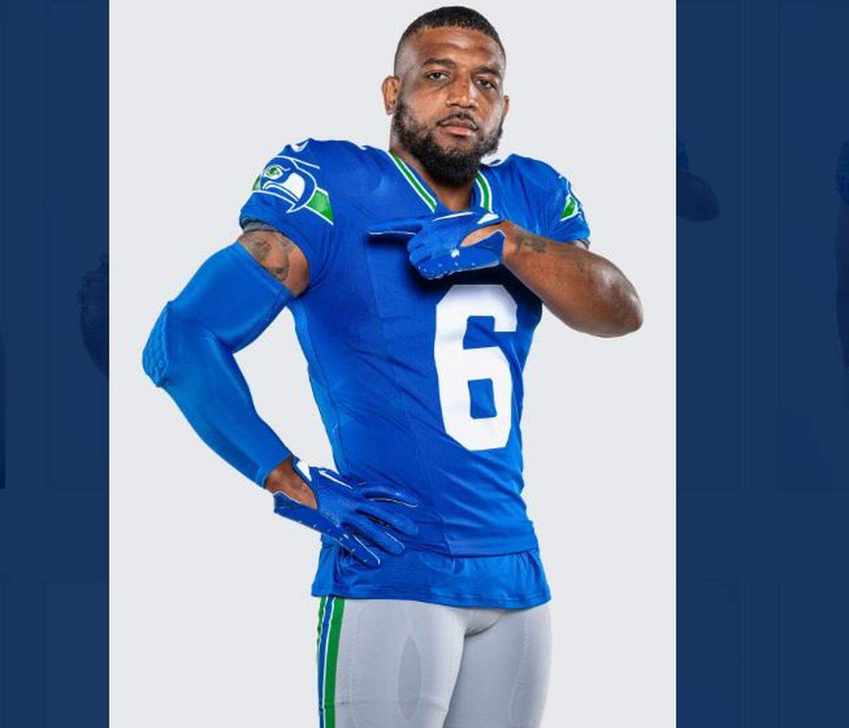 Pro Bowl safety Quandre Diggs shows off the 1990s, Kingdome-era throwback uniforms he and his Seahawks will wear Oct. 29, 2023, for a home game against the Cleveland Browns.