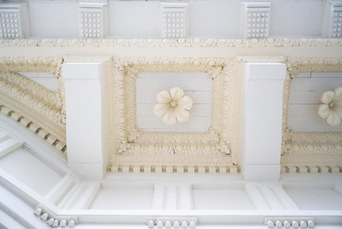 A view of architectural adornments painted in Philadelphia Cream and Lancaster White that run along the eves of the original Rust Mansion.