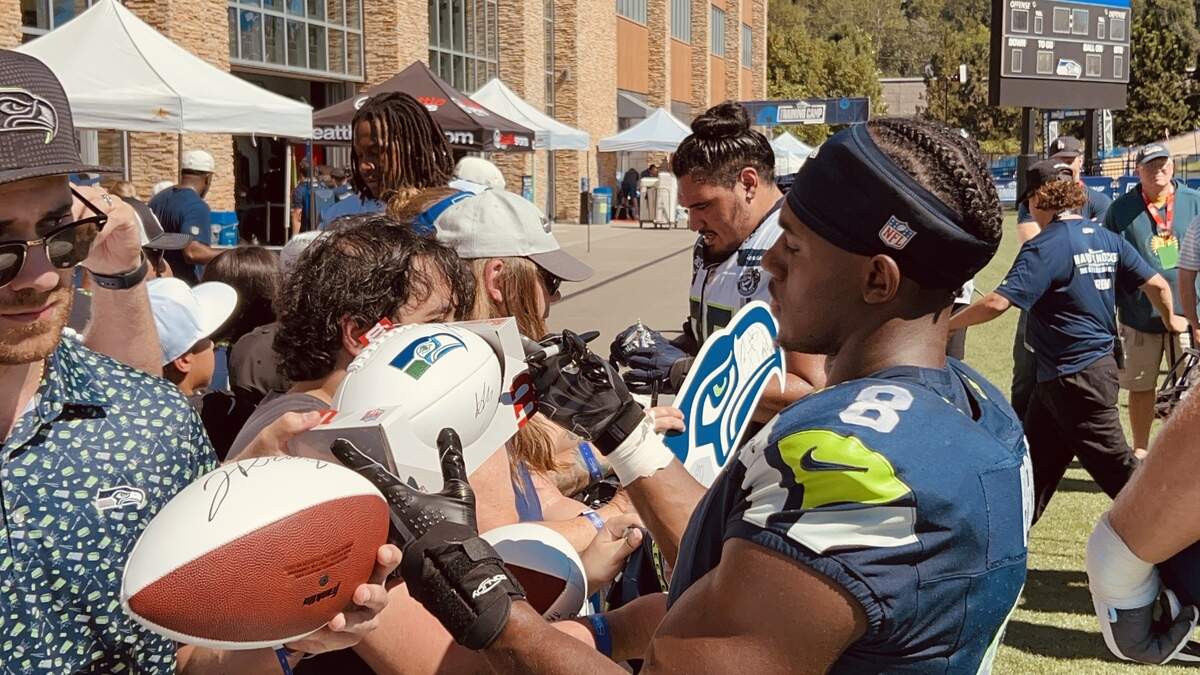 Rookie first-round draft choice Jadarian Price signs autographs for fans on the running back’s third day of Seattle Seahawks
