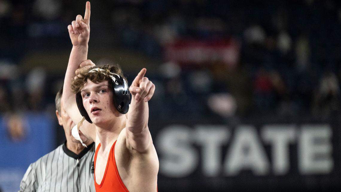 Orting’s Trevor Anderson lifts his arm in victory after beating Woodland’s Mathis Johns to win the Class 2A, 120-pound state title on Saturday, Feb. 22, 2025, at Mat Classic XXXVI at the Tacoma Dome in Tacoma, Wash.