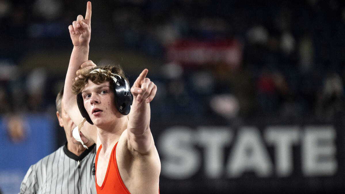 Orting’s Trevor Anderson lifts his arm in victory after beating Woodland’s Mathis Johns to win the Class 2A, 120-pound state title on Saturday, Feb. 22, 2025, at Mat Classic XXXVI at the Tacoma Dome in Tacoma, Wash.