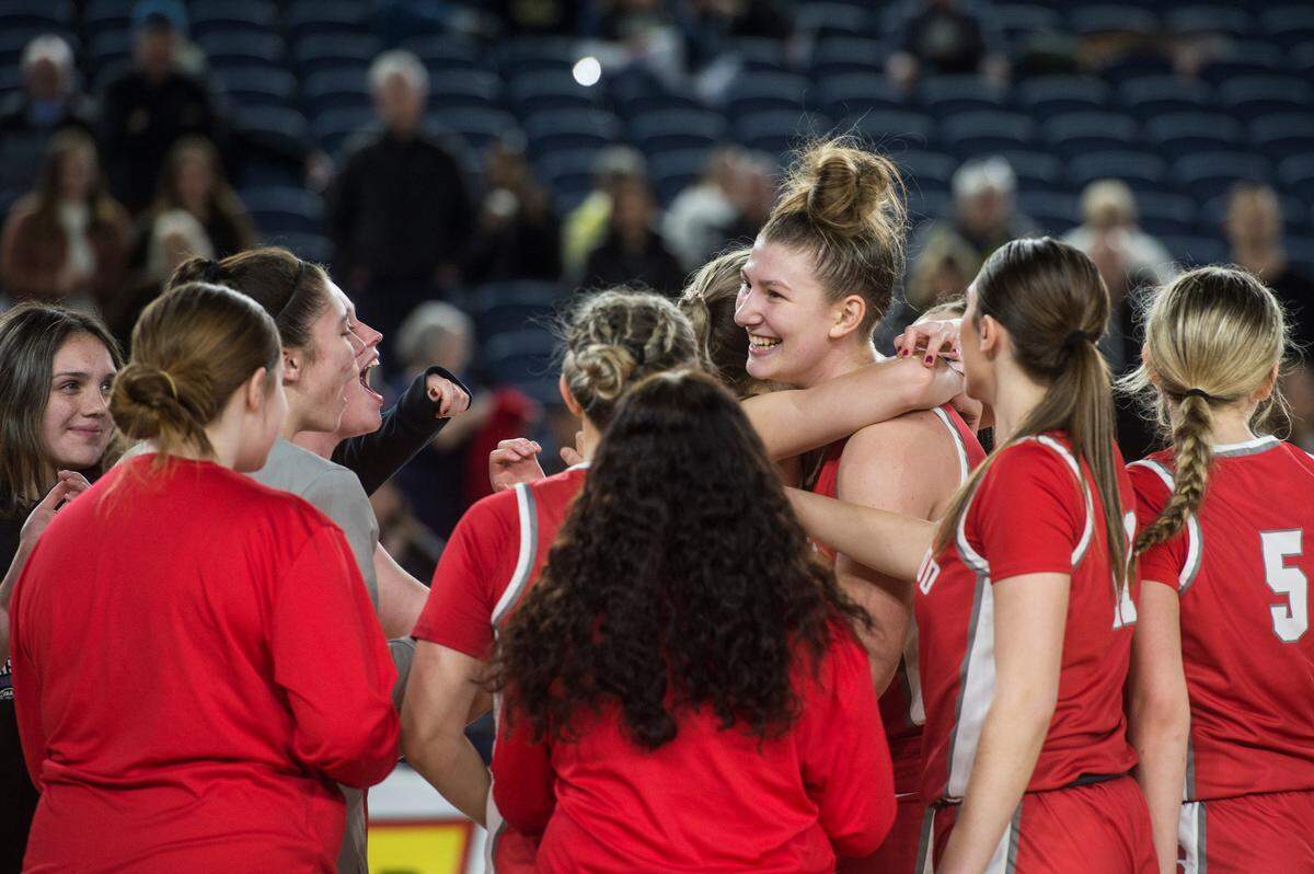 Stanwood forward Vivienne Berrett celebrates with teammates after making the game-winning basket against Lakeside of Seattle in the consolation round of the Class 3A girls state basketball tournament on Friday, March 3, 2023 at the Tacoma Dome in Tacoma, Wash.