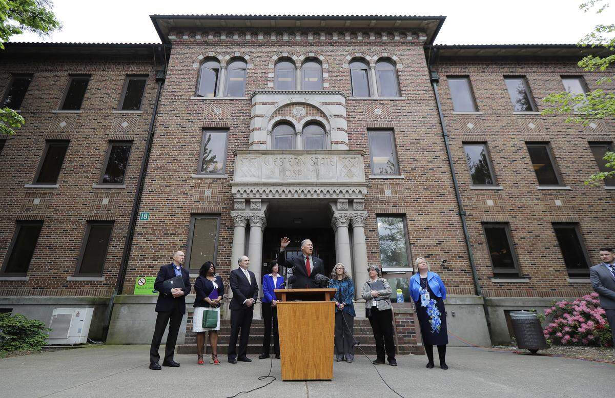 Washington Gov. Jay Inslee, center, speaks Friday, May 11, 2018, in front of Western State Hospital in Lakewood.