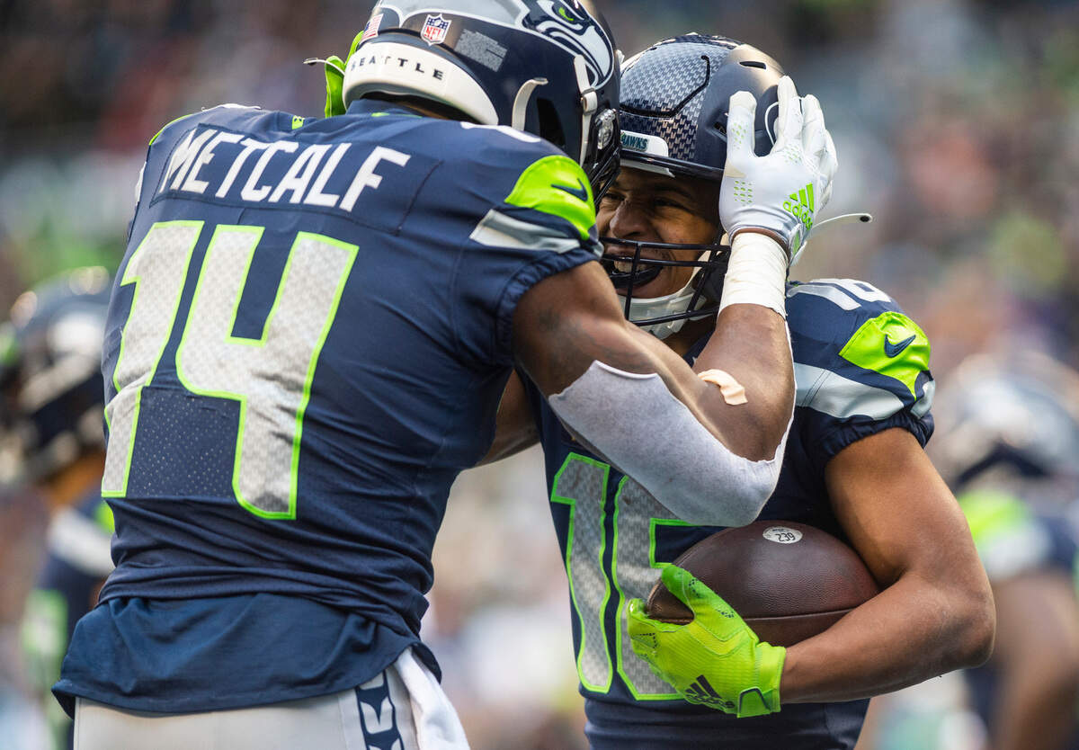 Seattle Seahawks wide receiver DK Metcalf (14) celebrates with Seattle Seahawks wide receiver Tyler Lockett (16) after Lockett scored the Seahawks first touchdown of the game in the second quarter of an NFL game against the Carolina Panthers at Lumen Field in Seattle Wash., on Dec. 11, 2022.